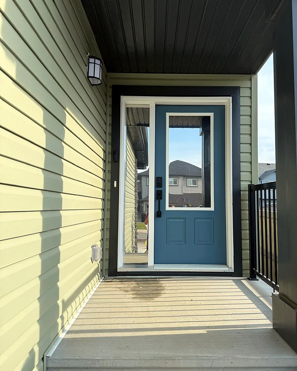 Blue front door with a glass panel and a tall sidelight
