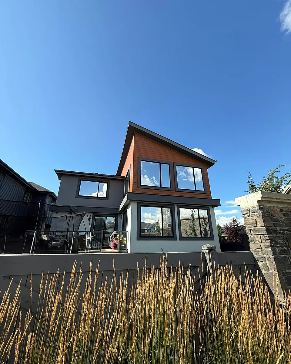 Modern two-story home with tinted windows on both floors